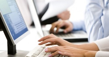 Female hands typing a letter on the keyboard