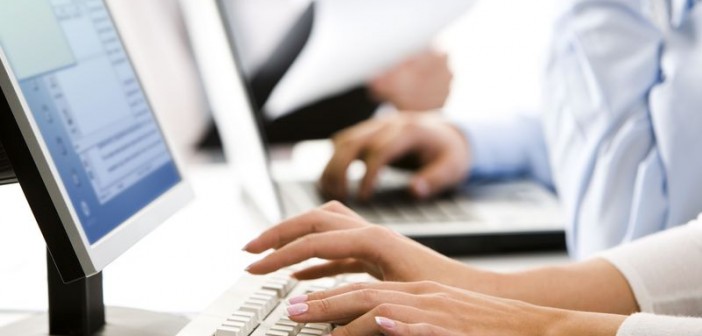 Female hands typing a letter on the keyboard